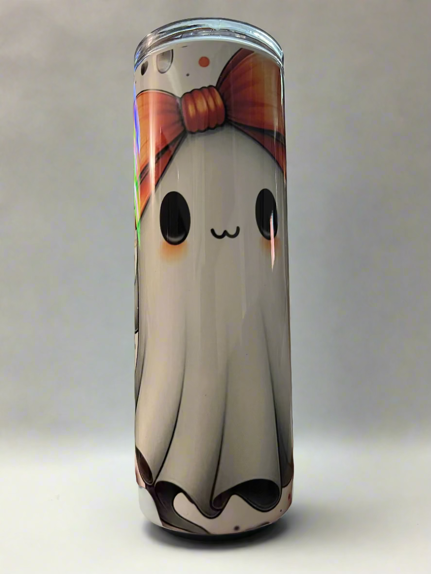 Tumbler with a cute ghost design held in a hand, blurred indoor background